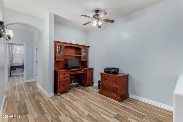 office with light wood-type flooring and ceiling fan