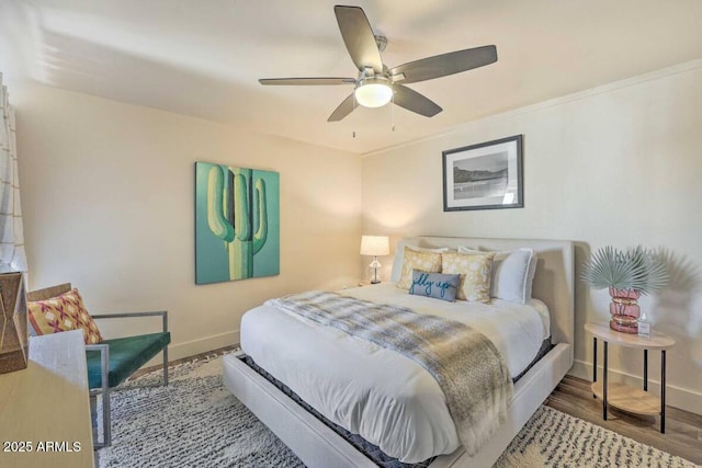 bedroom featuring ceiling fan, baseboards, and wood finished floors