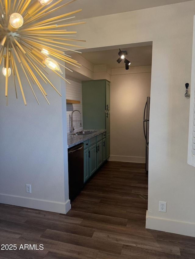 kitchen with dishwashing machine, a sink, green cabinets, freestanding refrigerator, and dark wood-style floors