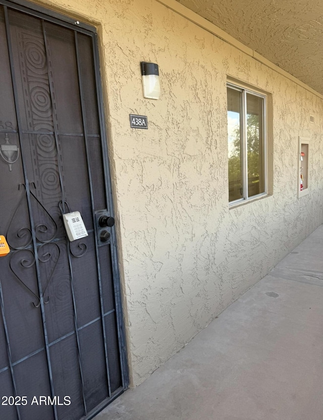 view of exterior entry featuring stucco siding