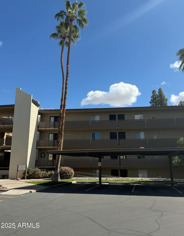 view of building exterior with covered parking