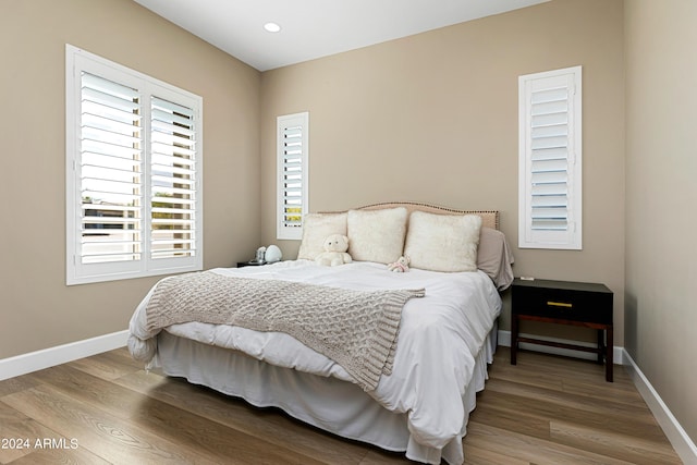 bedroom featuring recessed lighting, baseboards, and wood finished floors