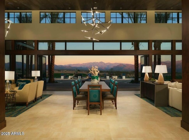 dining space with a notable chandelier and a towering ceiling