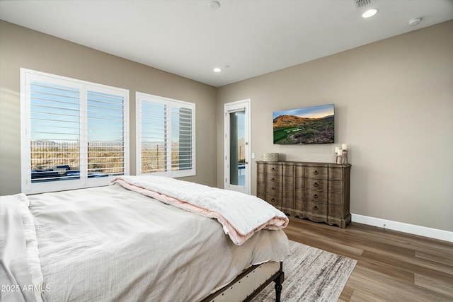 bedroom with recessed lighting, wood finished floors, visible vents, and baseboards