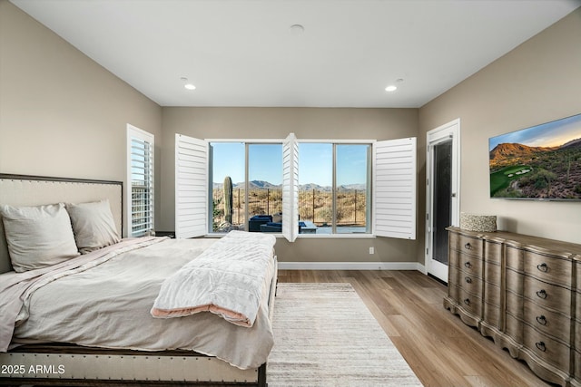 bedroom featuring recessed lighting, light wood-style flooring, and baseboards