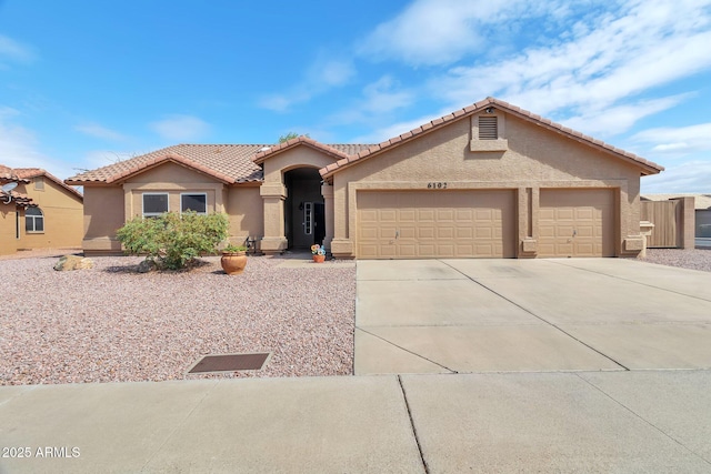 6102 W Shangri La Rd, Glendale, AZ 85304 - view of front of house with a garage, stucco siding, a tile roof, and concrete driveway