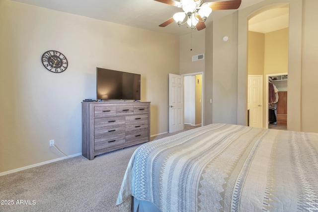 6102 W Shangri La Rd, Glendale, AZ 85304 - bedroom featuring visible vents, a towering ceiling, baseboards, arched walkways, and carpet