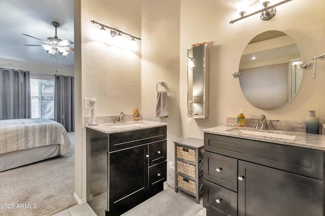 6102 W Shangri La Rd, Glendale, AZ 85304 - ensuite bathroom with a ceiling fan, two vanities, and a sink