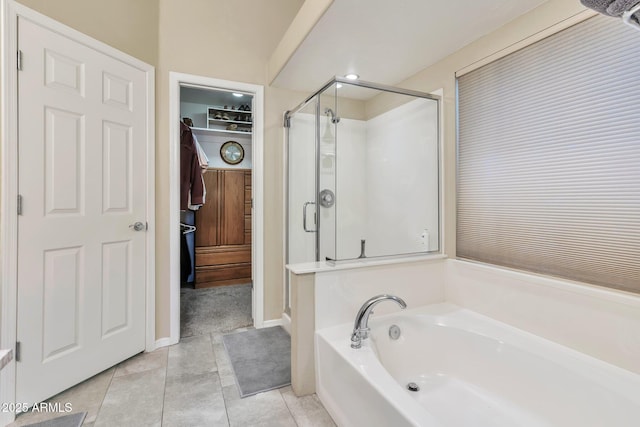 6102 W Shangri La Rd, Glendale, AZ 85304 - full bathroom featuring a garden tub, tile patterned floors, a spacious closet, and a shower stall