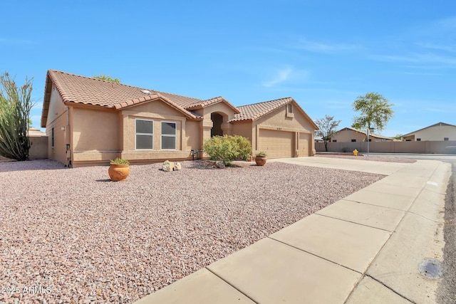 6102 W Shangri La Rd, Glendale, AZ 85304 - view of front of house with an attached garage, stucco siding, a tile roof, and concrete driveway