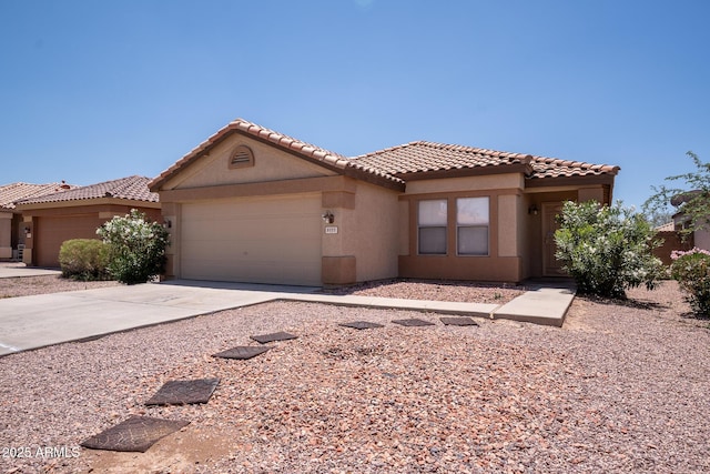 8055 W Sanna St, Peoria, AZ 85345 - mediterranean / spanish home with a garage, stucco siding, a tiled roof, and concrete driveway