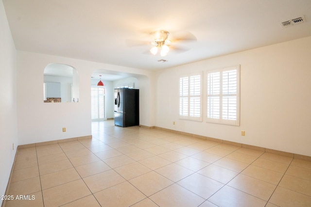 8055 W Sanna St, Peoria, AZ 85345 - unfurnished room with ceiling fan, light tile patterned flooring, arched walkways, and baseboards