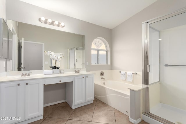 bathroom with tile patterned floors, vanity, and plus walk in shower