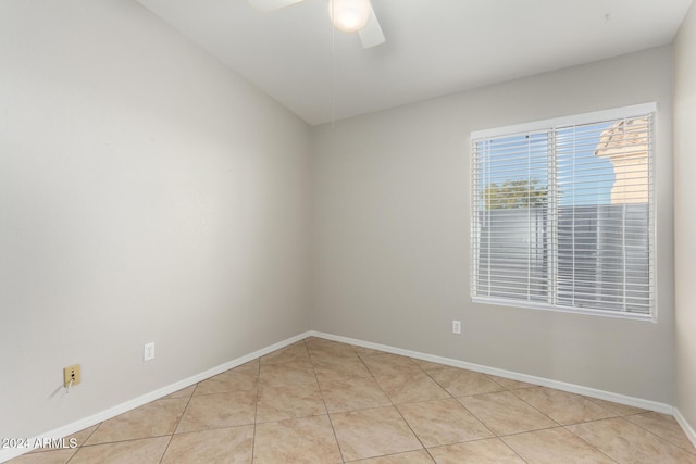 unfurnished room featuring ceiling fan and light tile patterned flooring