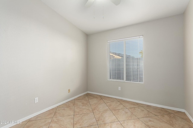 tiled spare room featuring ceiling fan