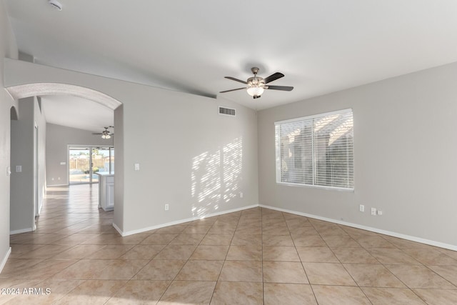 unfurnished room with ceiling fan, light tile patterned floors, and lofted ceiling