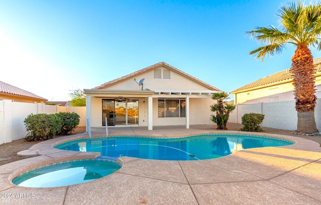 view of swimming pool with an in ground hot tub and a patio area