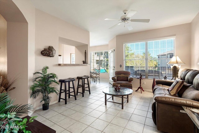 living room with ceiling fan and light tile patterned floors