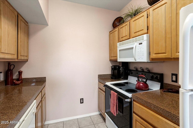 kitchen with light brown cabinetry, white appliances, and light tile patterned flooring