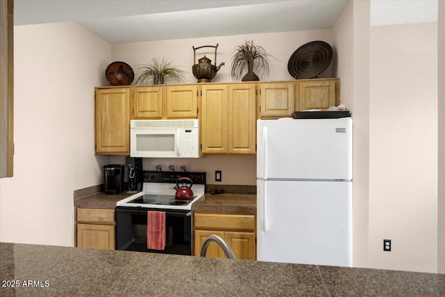 kitchen featuring light brown cabinetry, sink, and white appliances