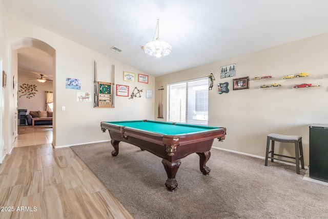 playroom featuring vaulted ceiling, arched walkways, visible vents, and baseboards