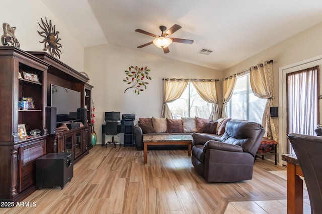 living room featuring visible vents, light wood-style flooring, lofted ceiling, and ceiling fan