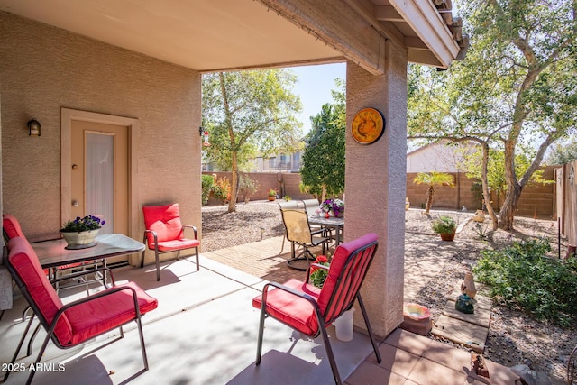 view of patio with outdoor dining space and a fenced backyard