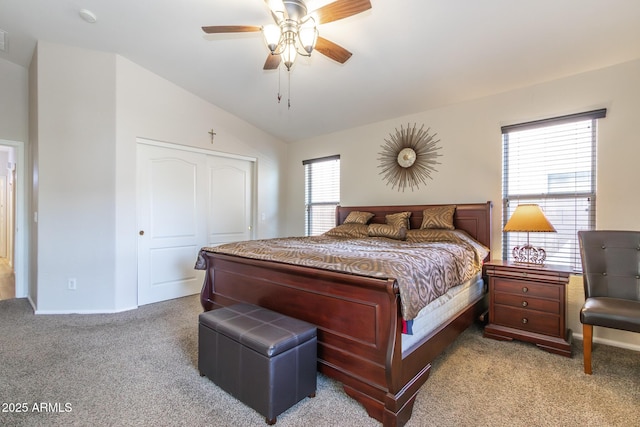 carpeted bedroom featuring vaulted ceiling, a closet, and ceiling fan