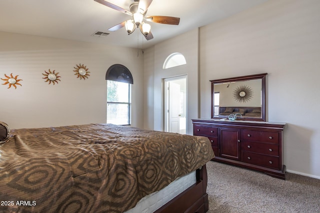 carpeted bedroom with visible vents and a ceiling fan