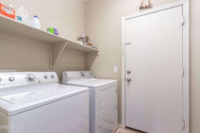 washroom featuring laundry area, light tile patterned flooring, and washing machine and dryer