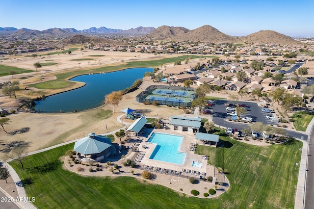 birds eye view of property with a water and mountain view