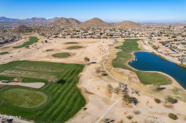 drone / aerial view featuring golf course view and a water and mountain view