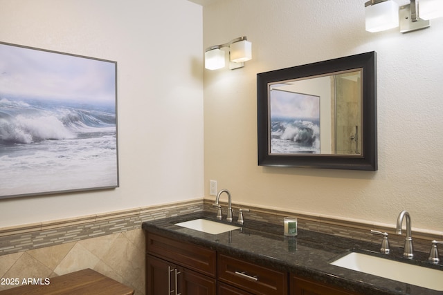 bathroom featuring a sink and double vanity