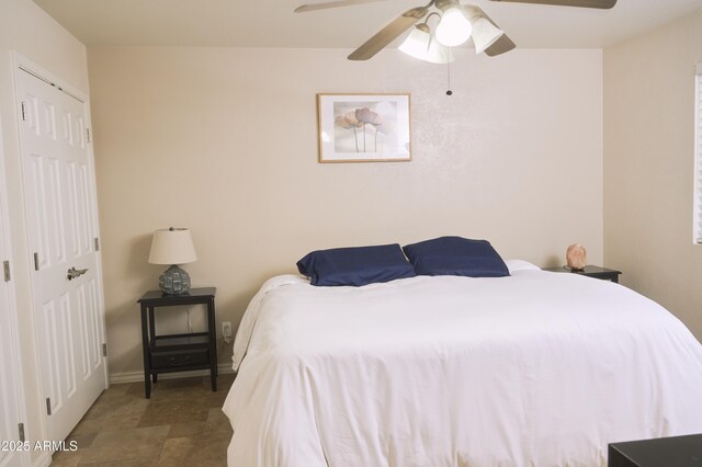 bedroom with baseboards and a ceiling fan