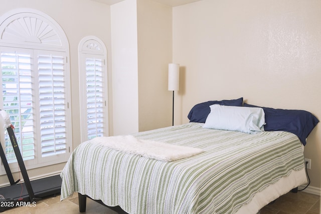 bedroom featuring tile patterned floors and multiple windows