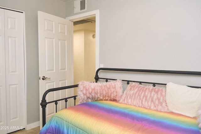bedroom featuring a closet, baseboards, and visible vents
