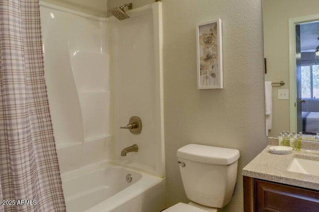 full bathroom with vanity, shower / tub combo with curtain, and toilet