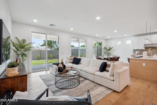 5537 E Earll Dr, Phoenix, AZ 85018 - living room featuring light wood-style floors and recessed lighting
