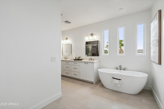 5537 E Earll Dr, Phoenix, AZ 85018 - full bath with a shower stall, double vanity, baseboards, a freestanding bath, and tile patterned floors