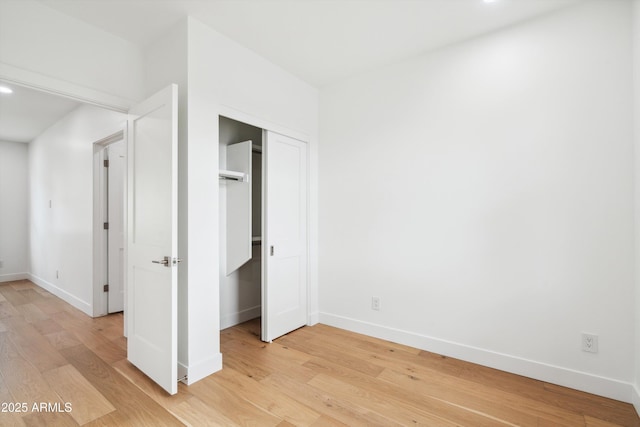 5537 E Earll Dr, Phoenix, AZ 85018 - unfurnished bedroom featuring baseboards, light wood-style flooring, and a closet
