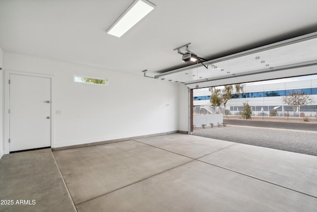 5537 E Earll Dr, Phoenix, AZ 85018 - garage featuring a garage door opener and baseboards