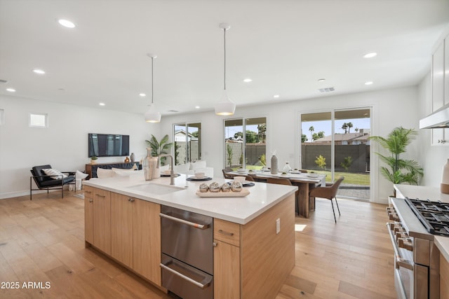 5537 E Earll Dr, Phoenix, AZ 85018 - kitchen featuring a sink, appliances with stainless steel finishes, light brown cabinetry, open floor plan, and light countertops
