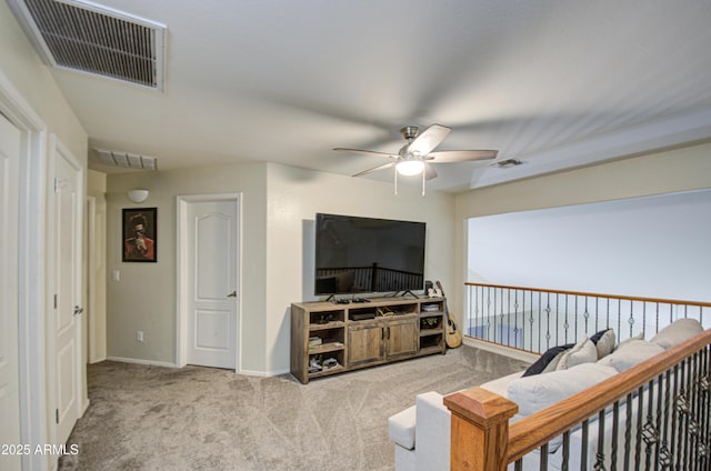 sitting room featuring light colored carpet and ceiling fan