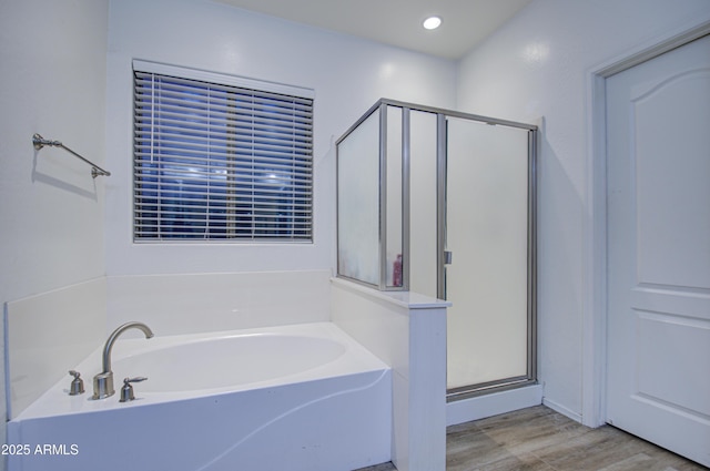 bathroom featuring separate shower and tub and hardwood / wood-style flooring