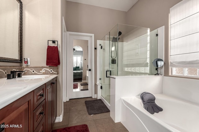 bathroom featuring tile patterned flooring, vanity, and separate shower and tub