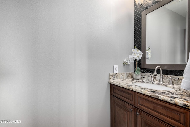 bathroom with tasteful backsplash and vanity