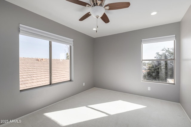 carpeted empty room featuring ceiling fan