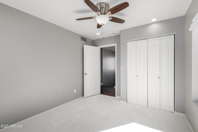 carpeted bedroom with ceiling fan and a closet