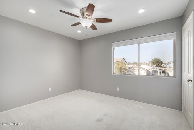 spare room with carpet floors and ceiling fan