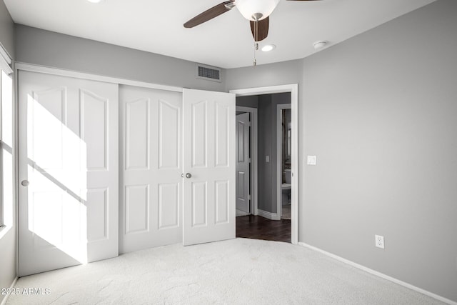 unfurnished bedroom with carpet floors, ceiling fan, and a closet